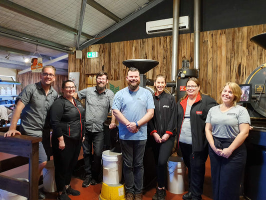 men and women posing for a photo in Yahava coffee brewery