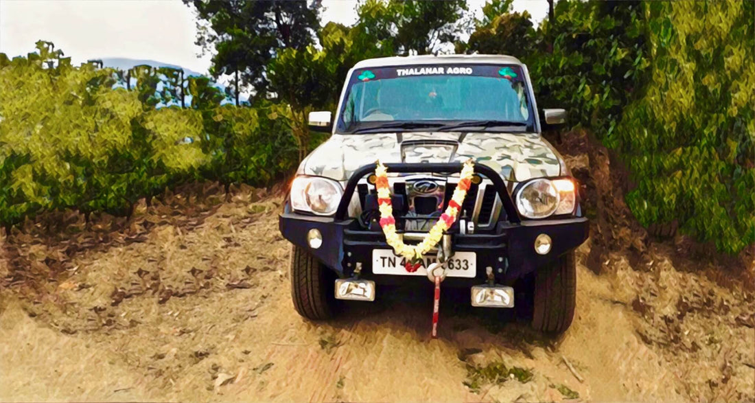 painting of a 4 wheel with a garland driving in the middle of the road