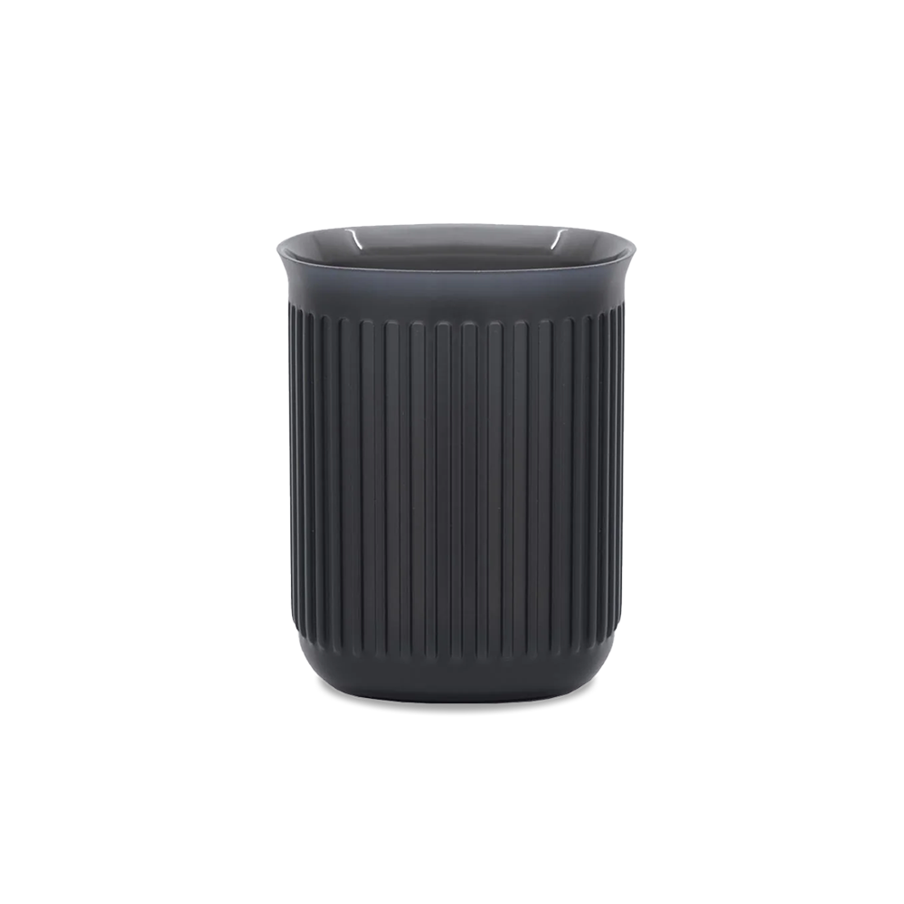 A black Aeropress replacement part, commonly referred to as a 'Go Cup', for making coffee.
