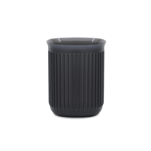 A black Aeropress replacement part, commonly referred to as a 'Go Cup', for making coffee.