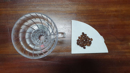 Filter paper & coffee beans. Learn how to brew filter coffee with Yahava.