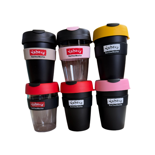 Six reusable coffee cups arranged in a 2x3 grid on a plain white background. The cups are primarily black with various colored lids and bands in yellow, pink, red, and white, featuring the brand name 'Yahava' printed on the labels.