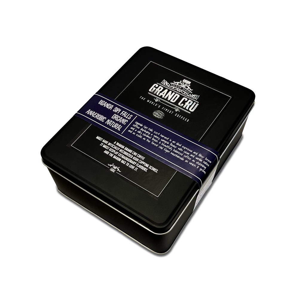 A black tin for Grand Cru: Uganda Sipi Falls Organic with a label on the top.