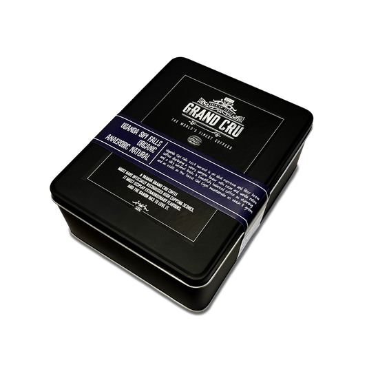 A black tin for Grand Cru: Uganda Sipi Falls Organic with a label on the top.