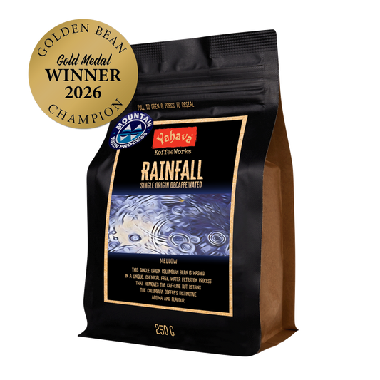 Yahava KoffeeWorks Rainfall Single Origin Decaffeinated 250g coffee beans with Mountain Water Process certification and 2026 Golden Bean Gold Medal Winner Champion award badge.