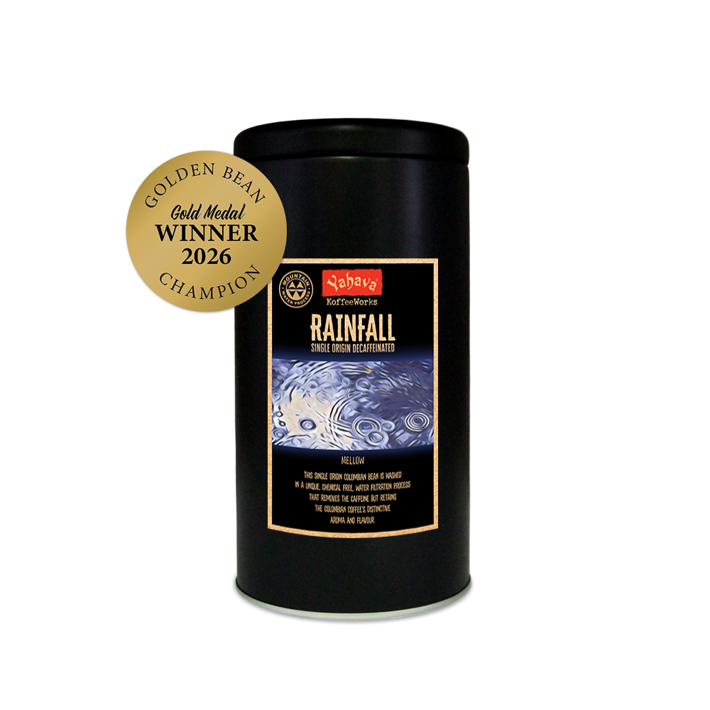 Yahava KoffeeWorks Rainfall Single Origin Decaffeinated coffee in a 500g storage tin with Mountain Water Process certification and 2026 Golden Bean Gold Medal Winner Champion award badge.